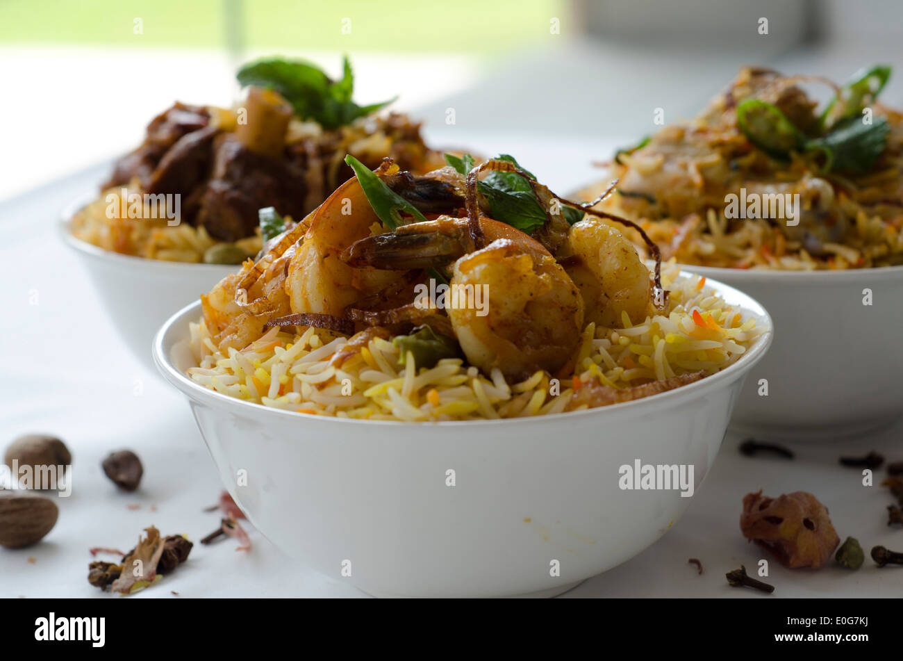 Biryani, a dish made by slow cooking fragrant rice with herbs and spices alongside, vegetables, meats or seafood.  Stock Photo