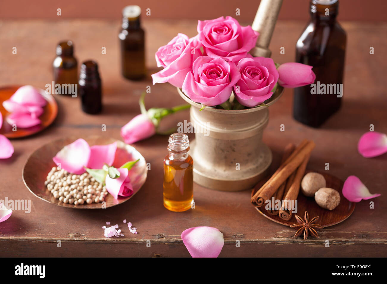 spa and aromatherapy set with rose flowers mortar and spices Stock Photo