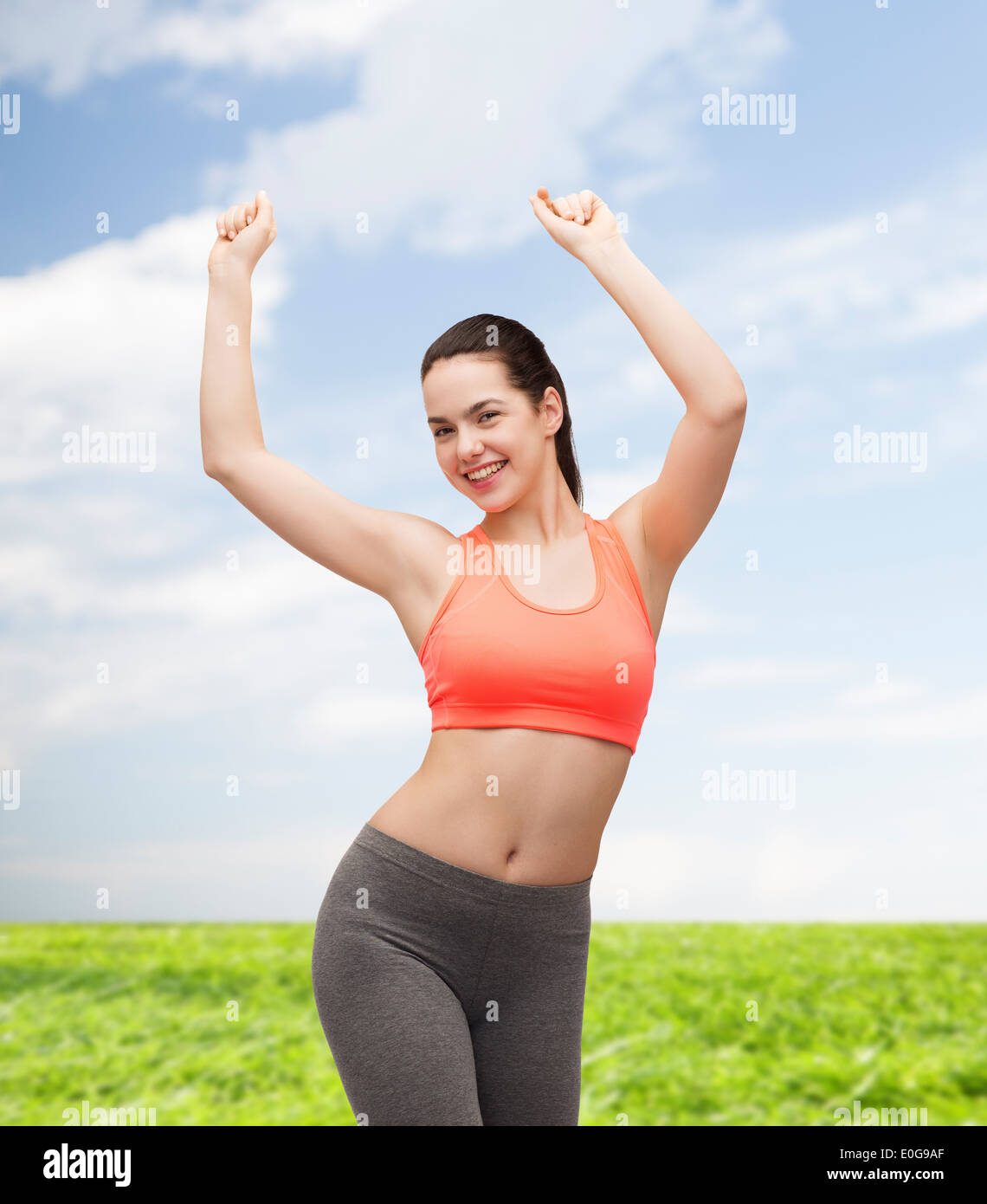 smiling teenage girl in sportswear dancing Stock Photo