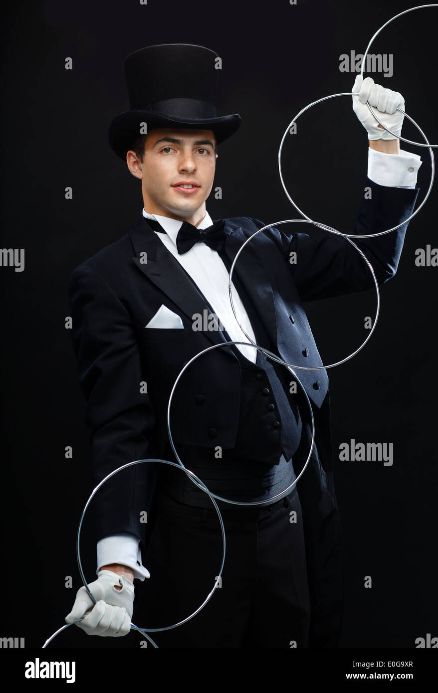 magician showing trick with linking rings Stock Photo