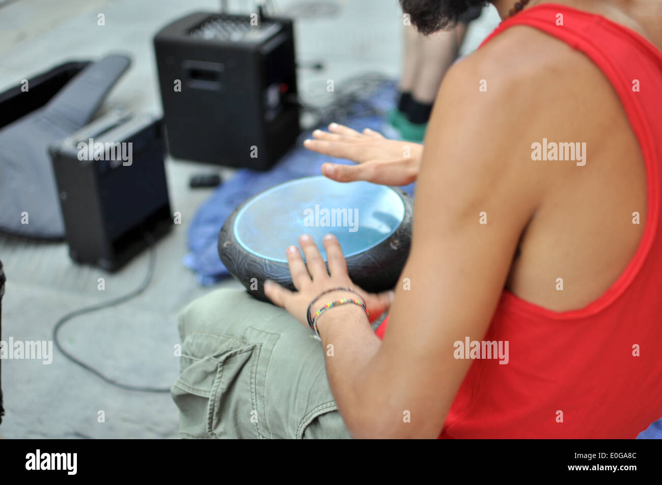 Street musician playing darbuka, percussion instrument like a drum