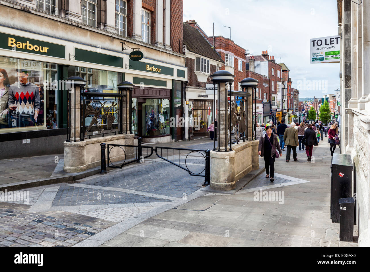 Peascod shopping street with decorative gates and trendy shops - Windsor, Berkshire, UK Stock Photo