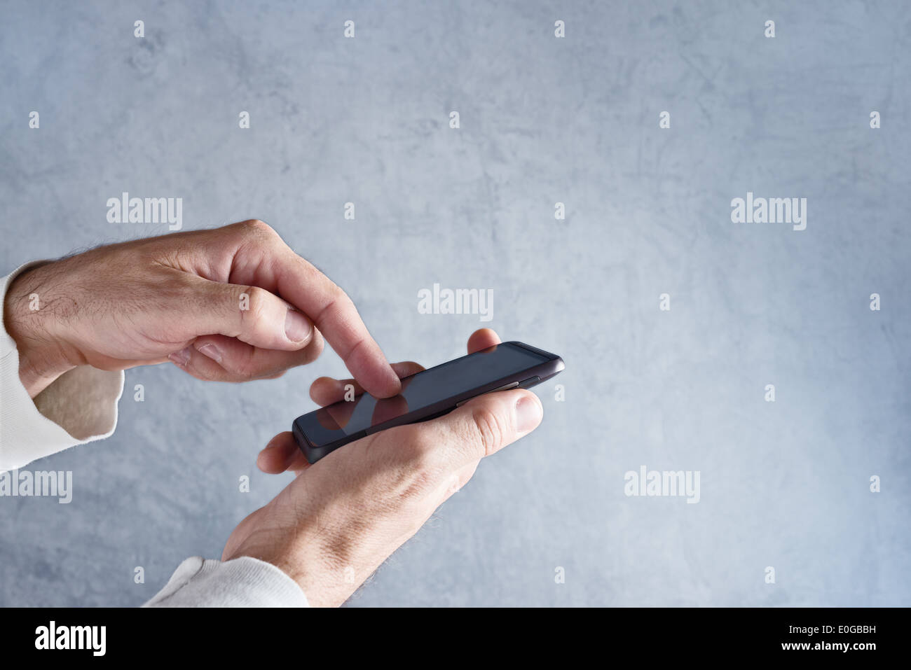 Hands holding mobile smart phone with touch screen. Stock Photo