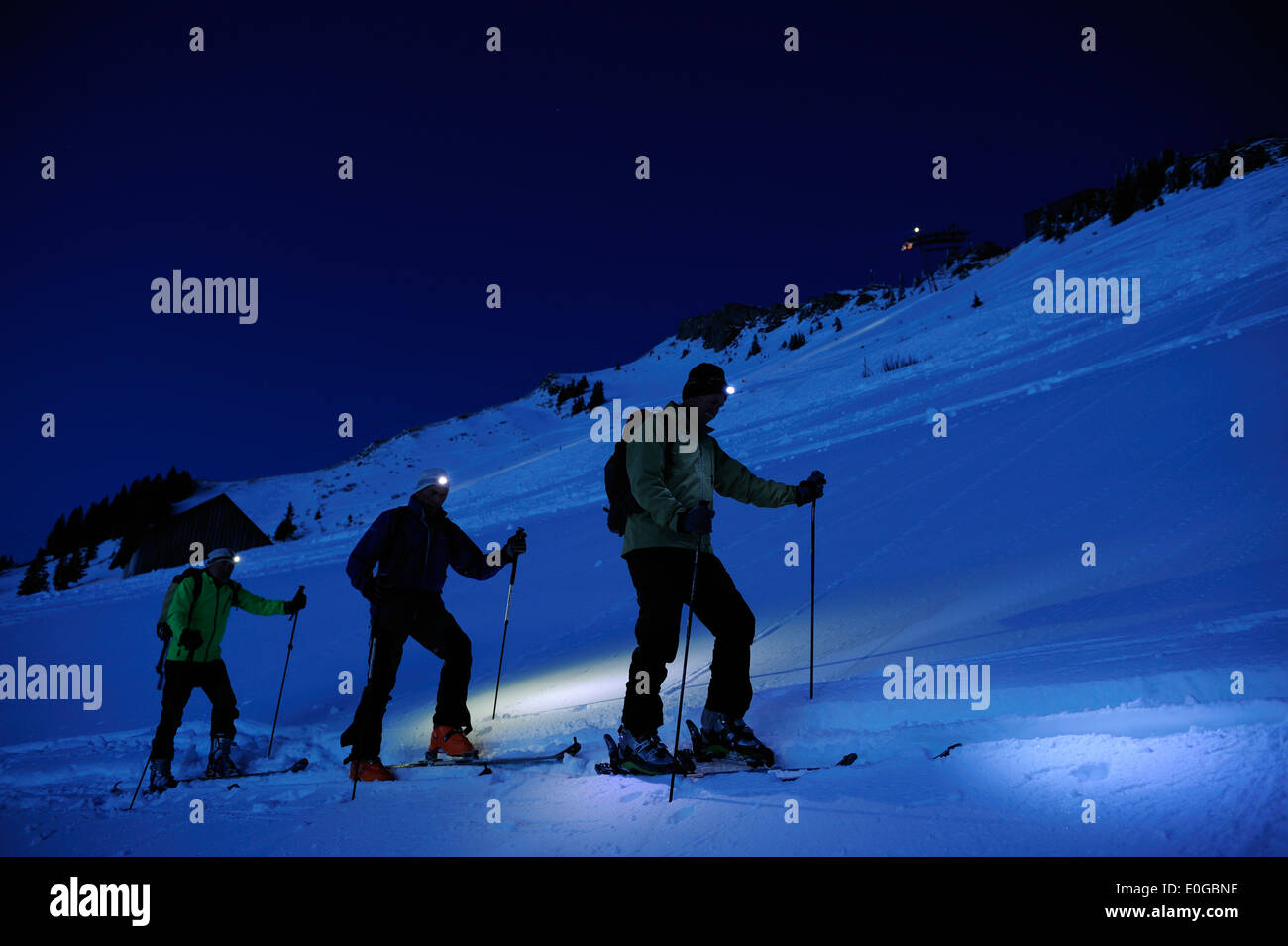 Three Men Backcountry Skiing At Night Ascent To Hut Staufner Haus