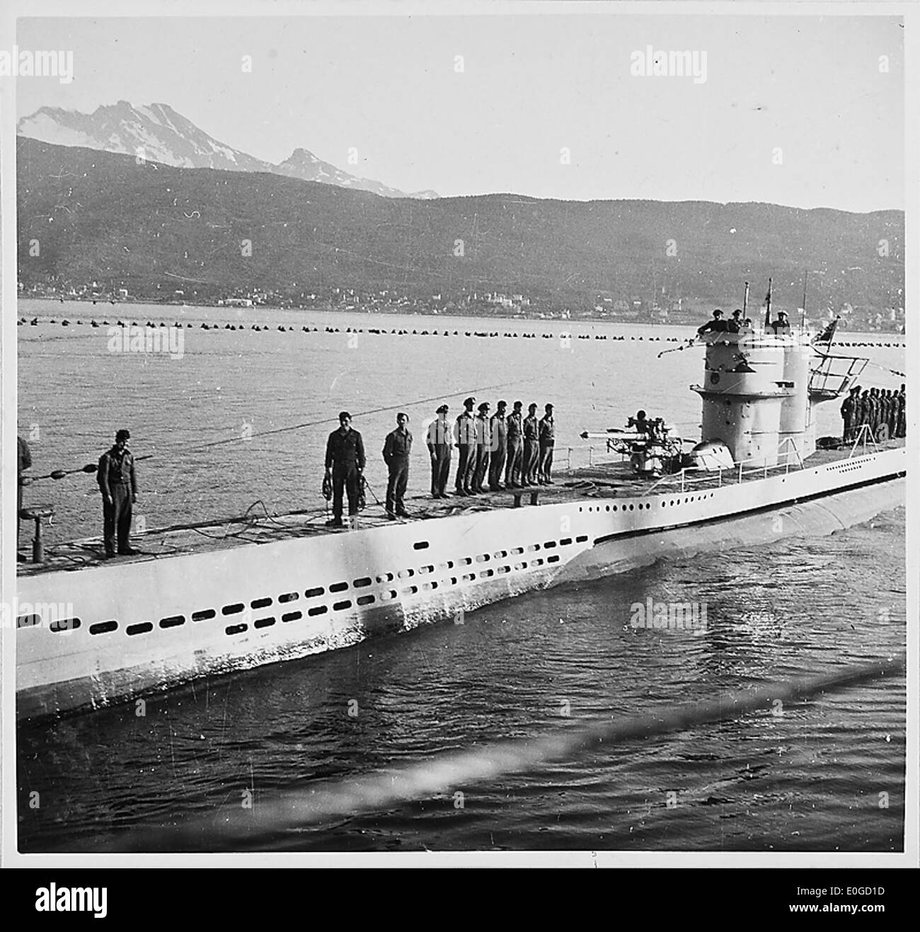 A photograph depicting U-boats entering port during World War II, showcasing the role of German submarines in the war. The image captures the technological and military significance of U-boats. Stock Photo