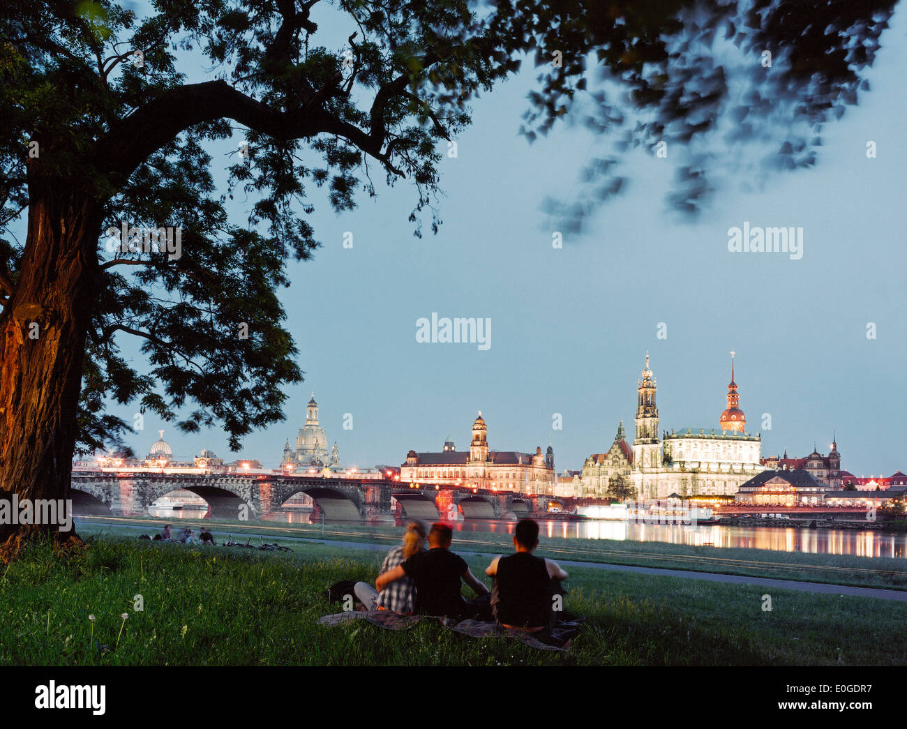 Young people looking at Canaletto-view, Dresden skyline in the evening, Elbe River, Dresden, Saxony, Germany Stock Photo