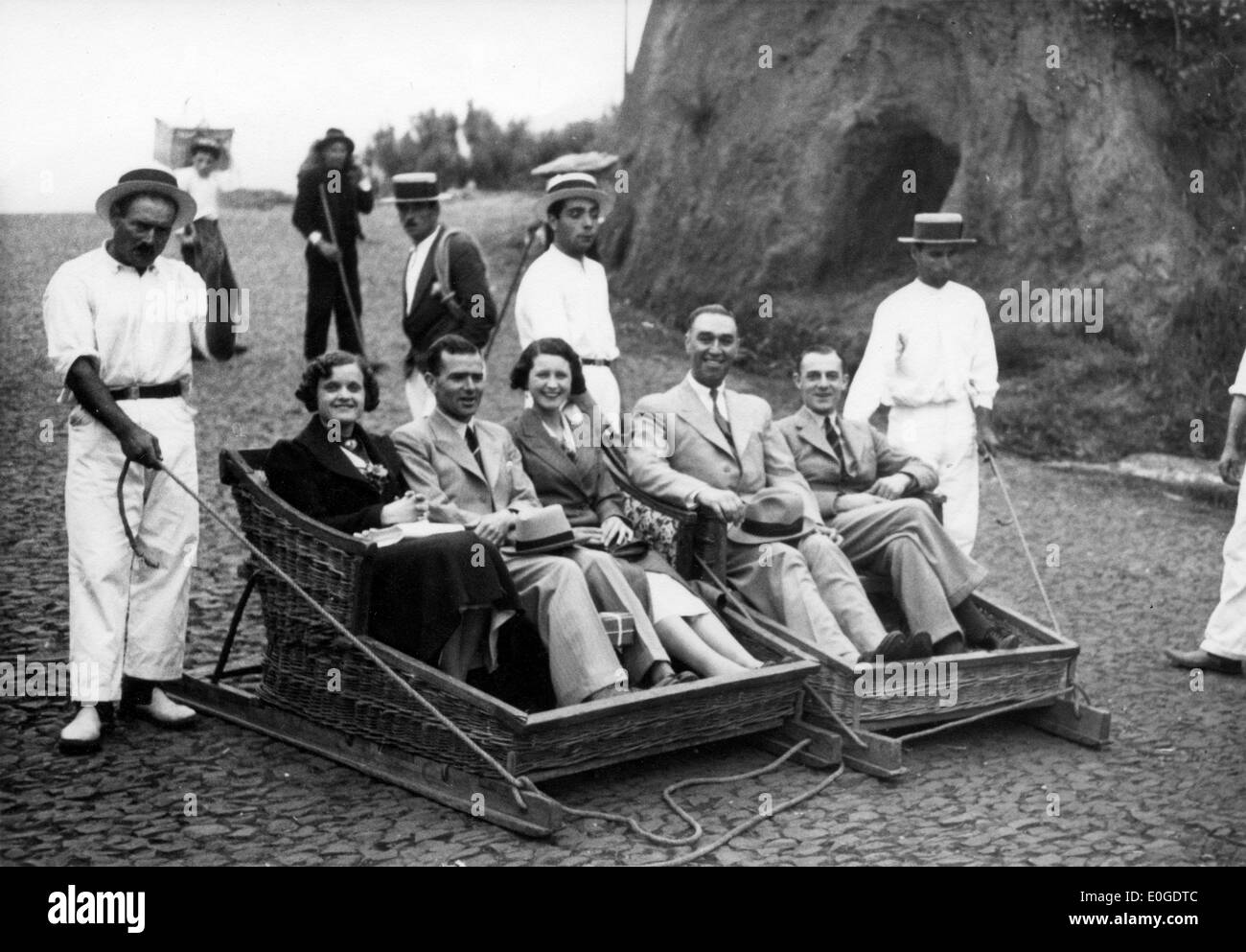 Tourists ride traditional toboggan between Monte and Funchal in Madeira Portugal 1940s 1950s travel holiday Stock Photo