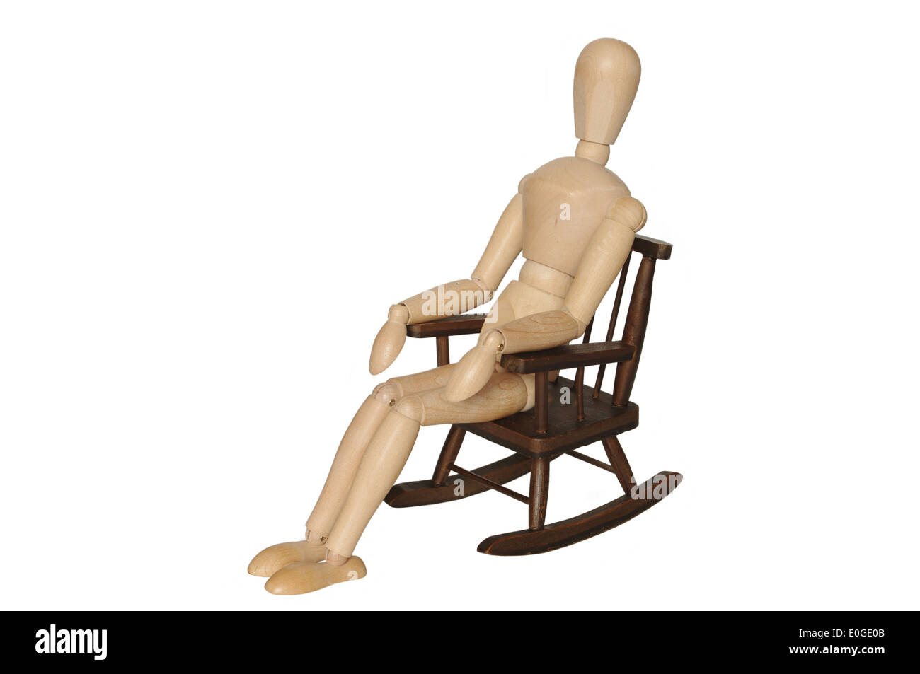 wooden dummy sitting on armchair on white background Stock Photo