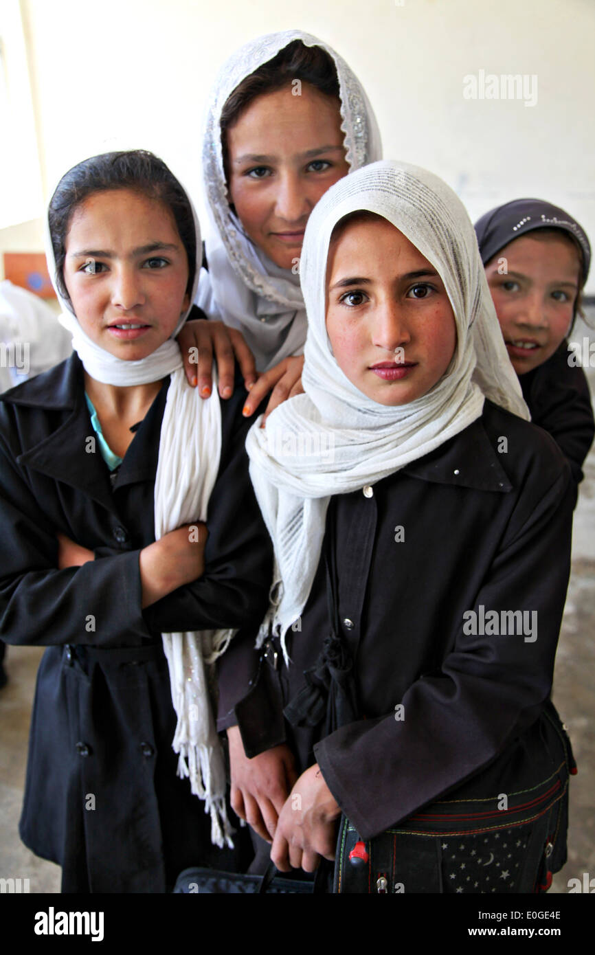 A group of Afghan school girls wearing hijab in a classroom of a schoolhouse April 23, 2014 in Parwan province, Afghanistan. Stock Photo
