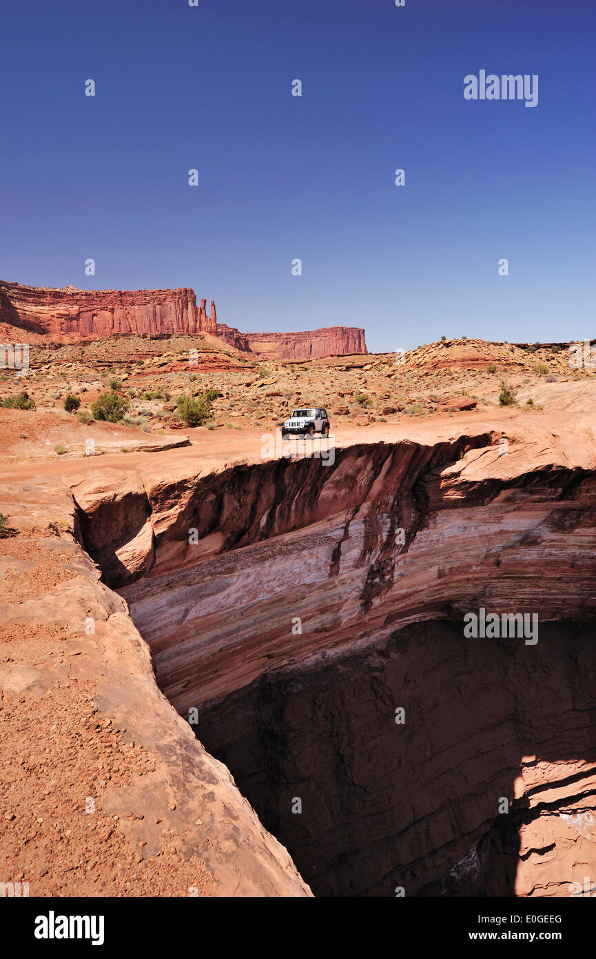 Jeep driving at brim above Colorado River, White Rim Drive, White Rim Trail, Island in the Sky, Canyonlands National Park, Moab, Stock Photo