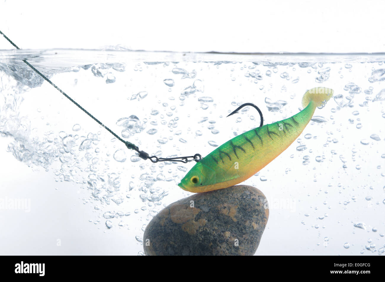 artificial angling bait on stone in water Stock Photo Alamy