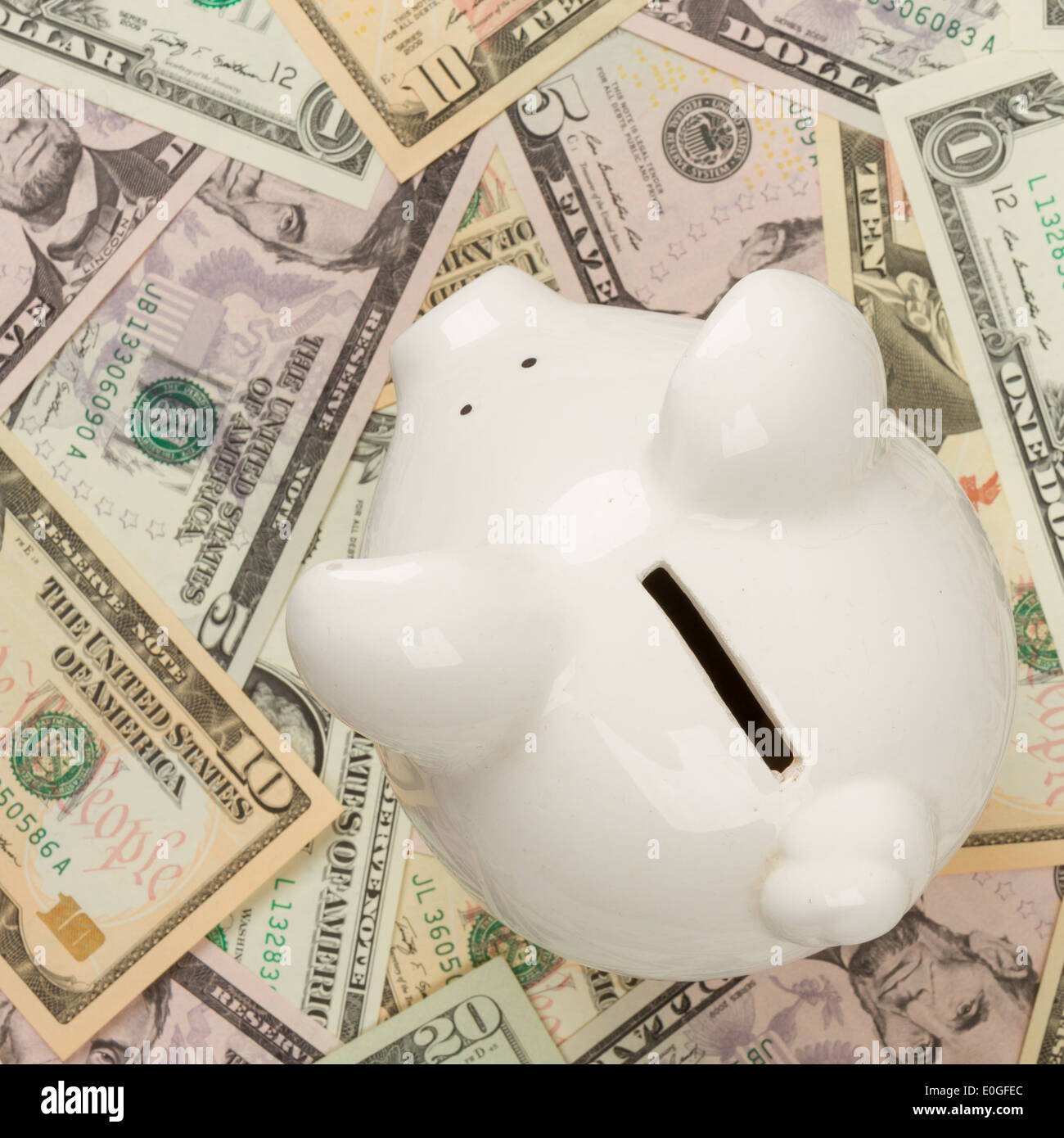 Piggy bank on 1 ,5, 10 and 20 dollar bills, focus on the pig Stock Photo
