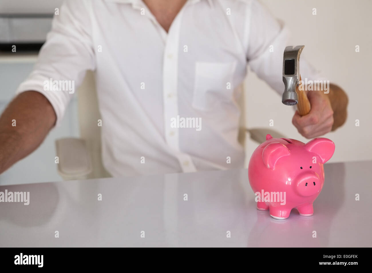 Hammer smashing piggy bank hi-res stock photography and images - Alamy