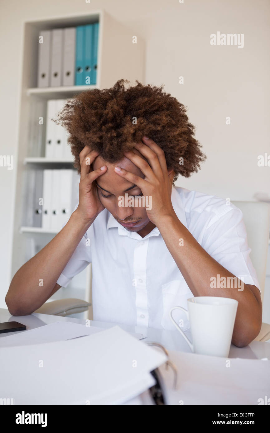 Casual stressed businessman with his head down at desk Stock Photo Alamy