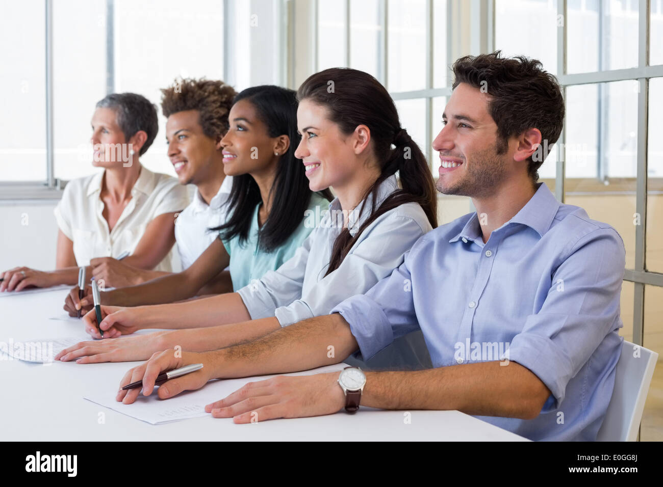 Business people attentive at presentation Stock Photo