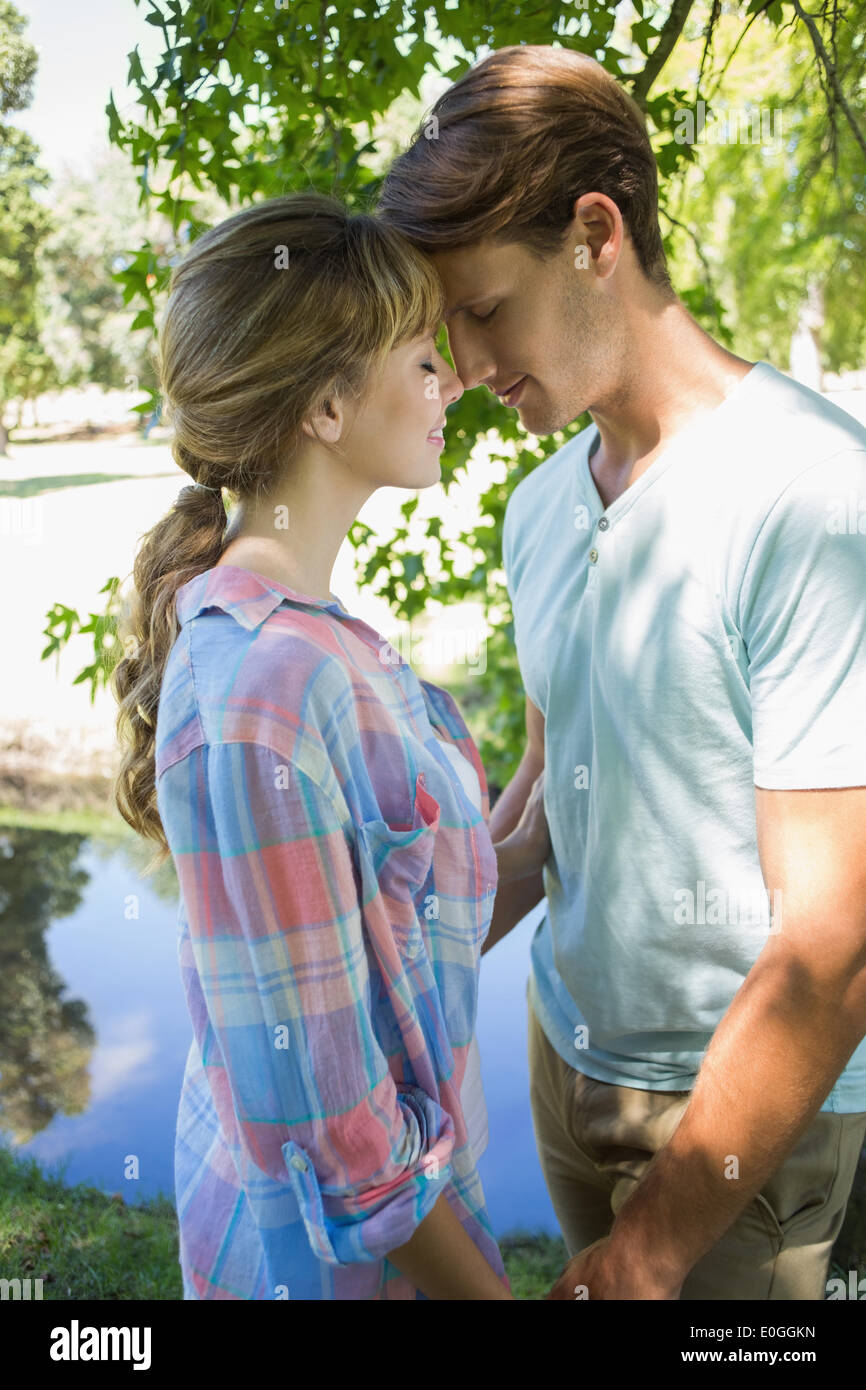 Close young couple standing together in the park Stock Photo