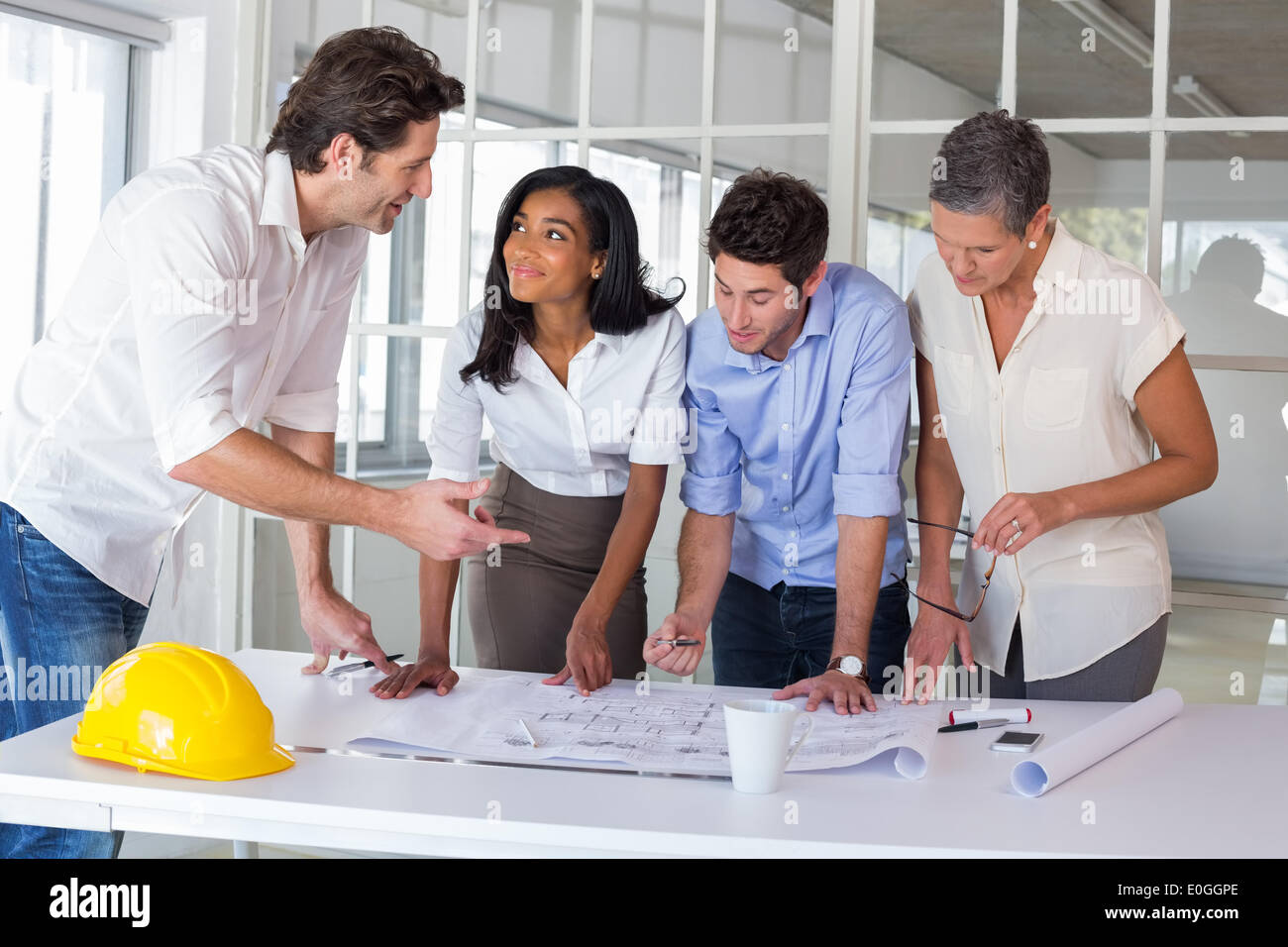 Team architects going over blueprints hi-res stock photography and ...