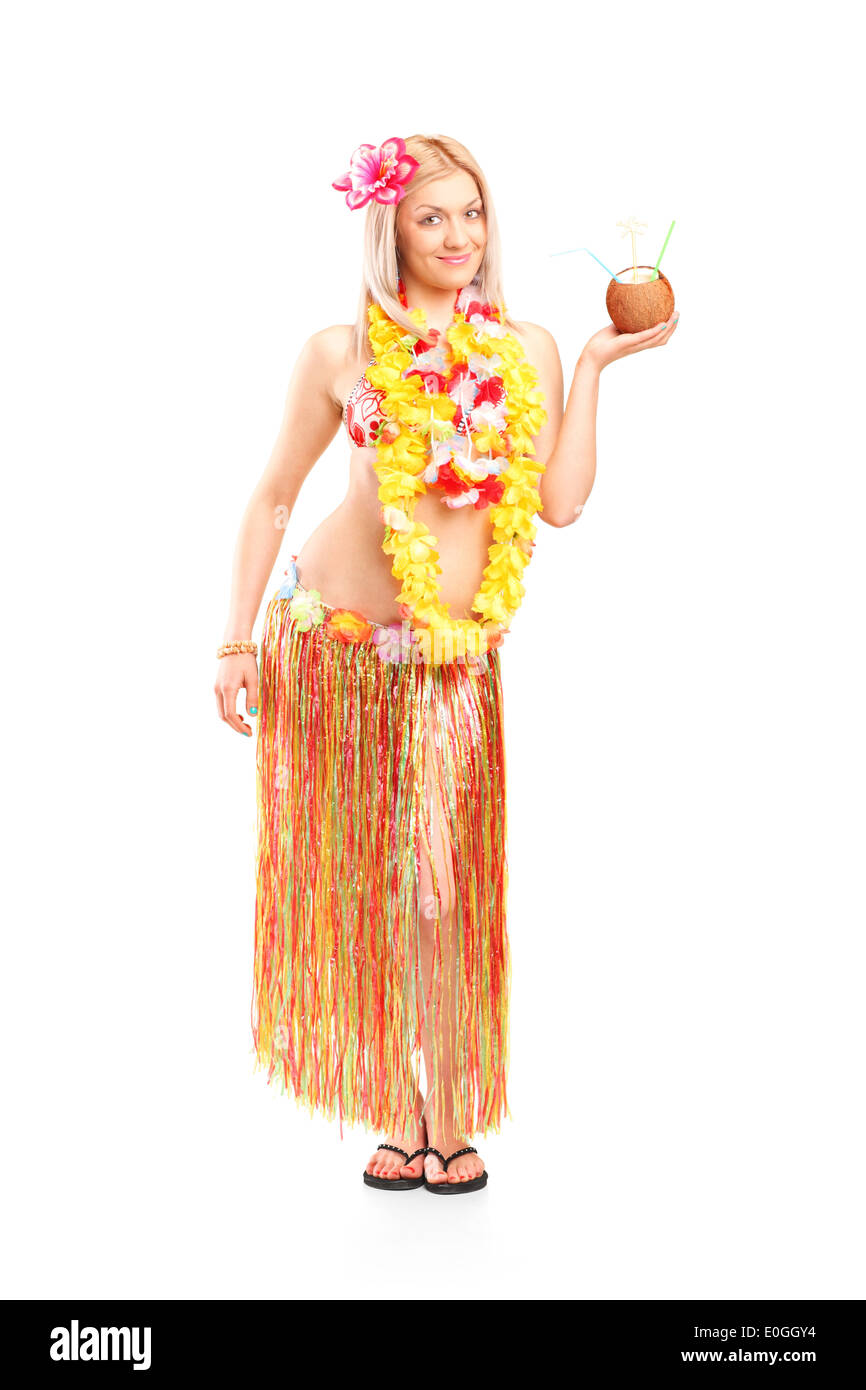 Full length portrait of a woman holding an exotic cocktail in a coconut Stock Photo
