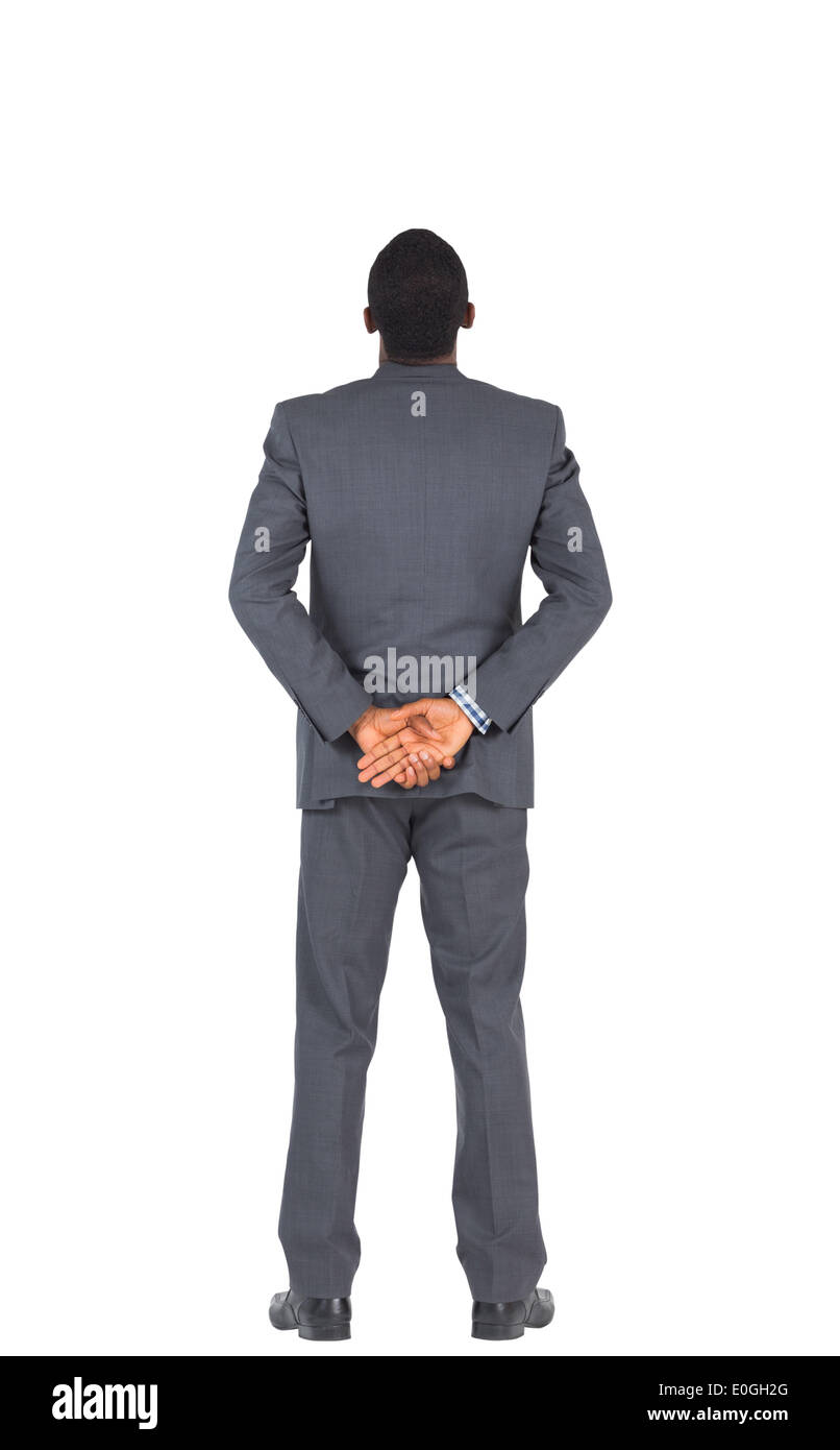Businessman standing with hands behind back Stock Photo Alamy