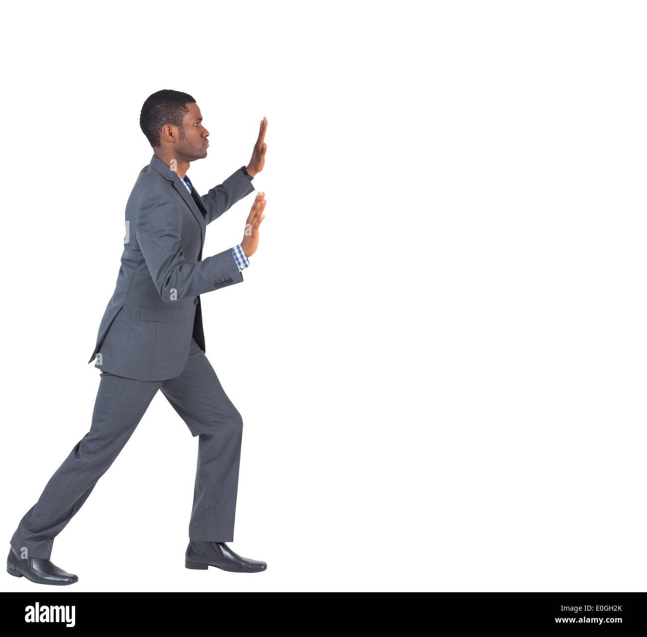 Businessman standing and pushing with hands Stock Photo - Alamy