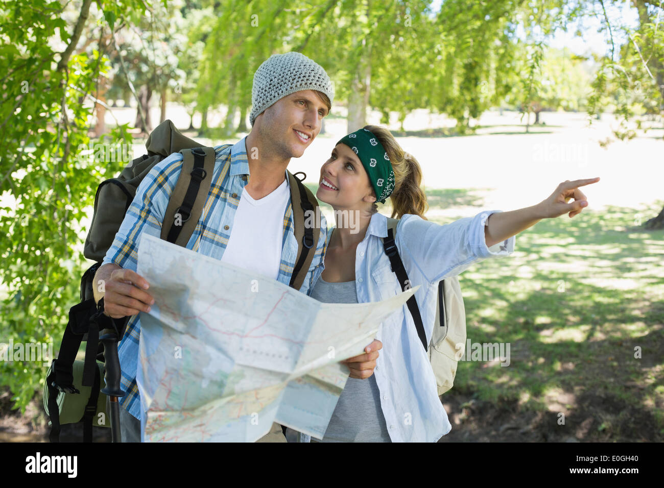 Active couple on a hike consulting the map Stock Photo - Alamy