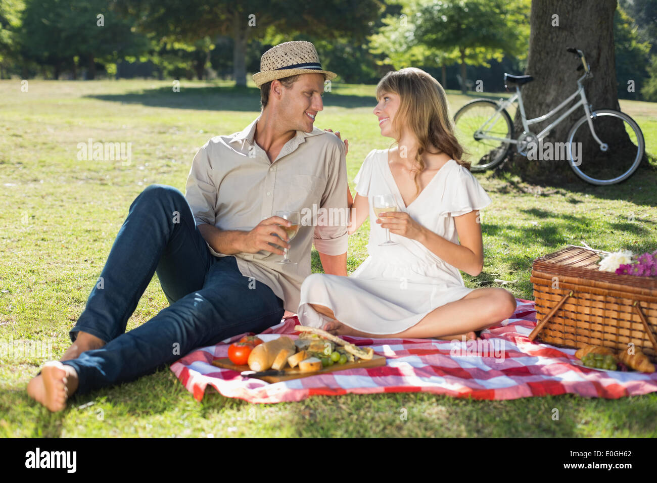 Cute couple drinking white wine on a picnic Stock Photo - Alamy