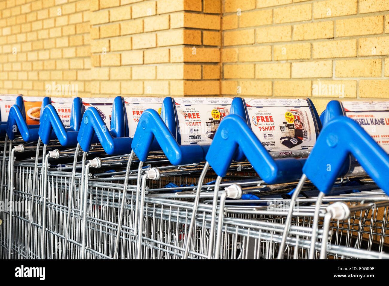 Shopping trolleys trollies stacked outside a Tesco supermarket. Stock Photo