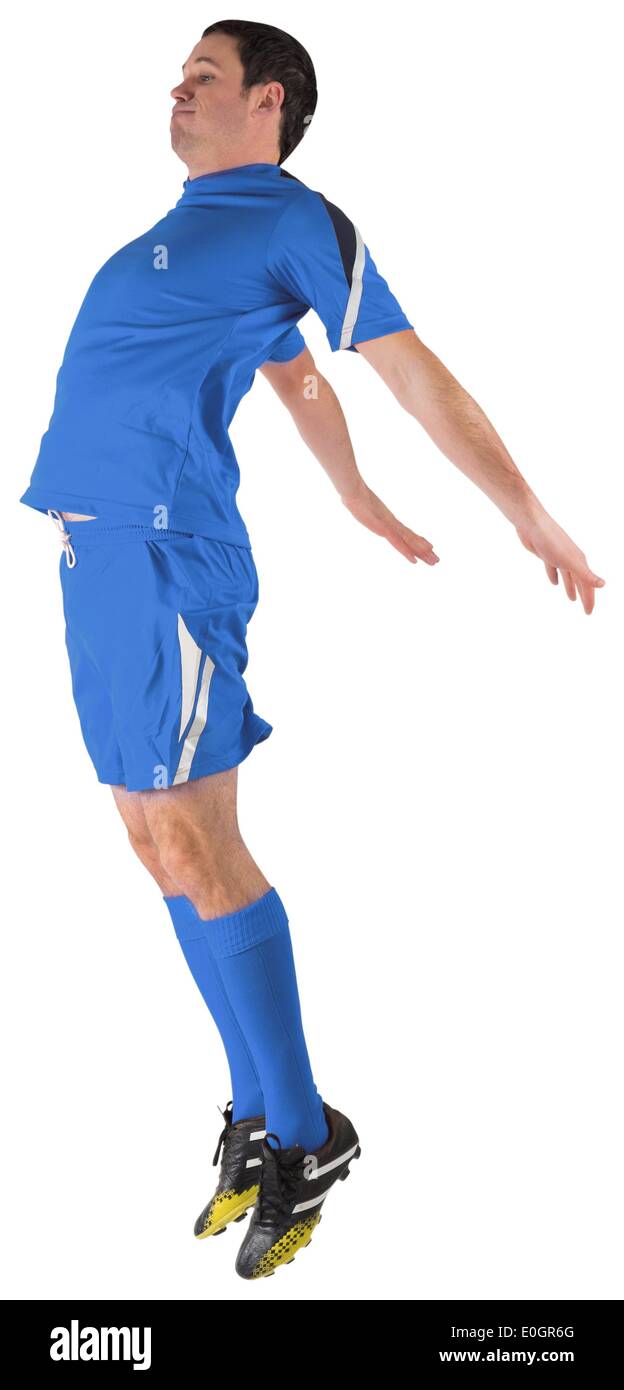 Football player in blue jumping Stock Photo - Alamy