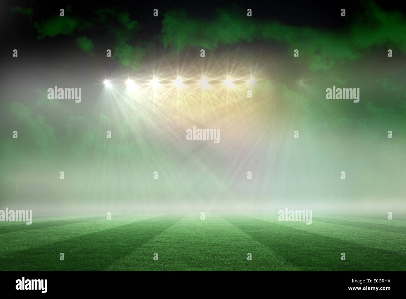 Football pitch under green sky and spotlights Stock Photo