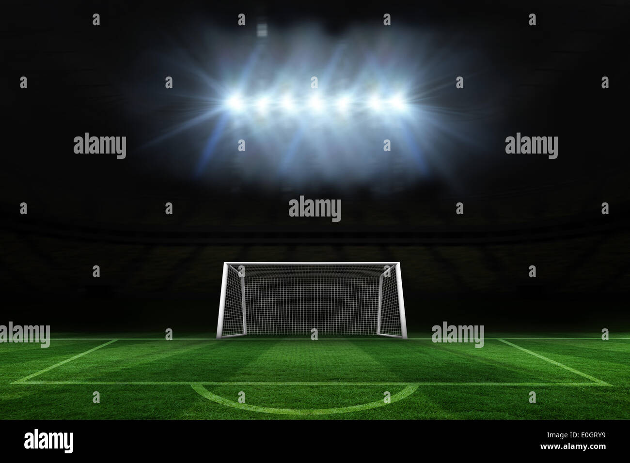 Football pitch and goal under spotlights Stock Photo