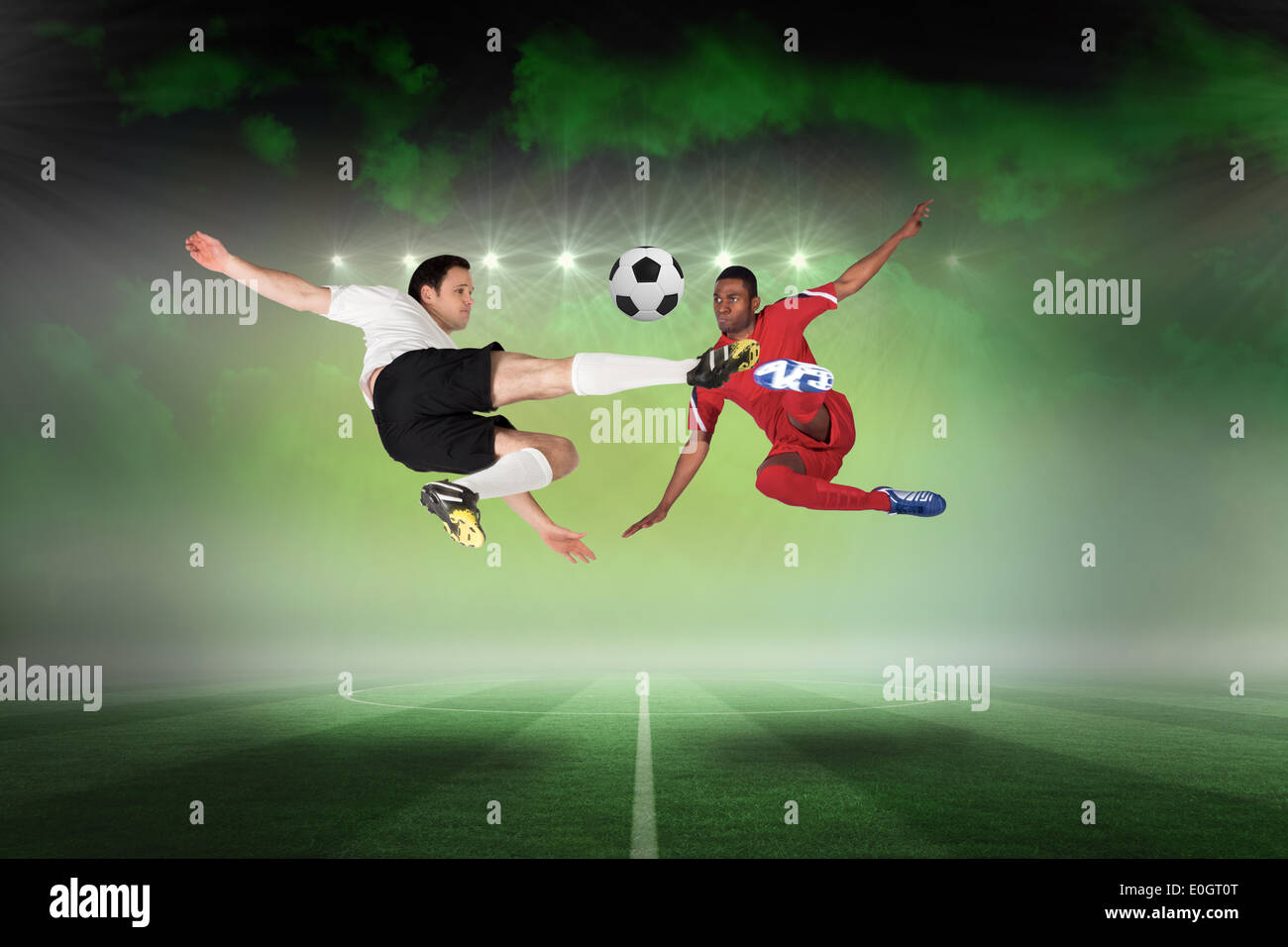 Football players tackling for the ball Stock Photo Alamy