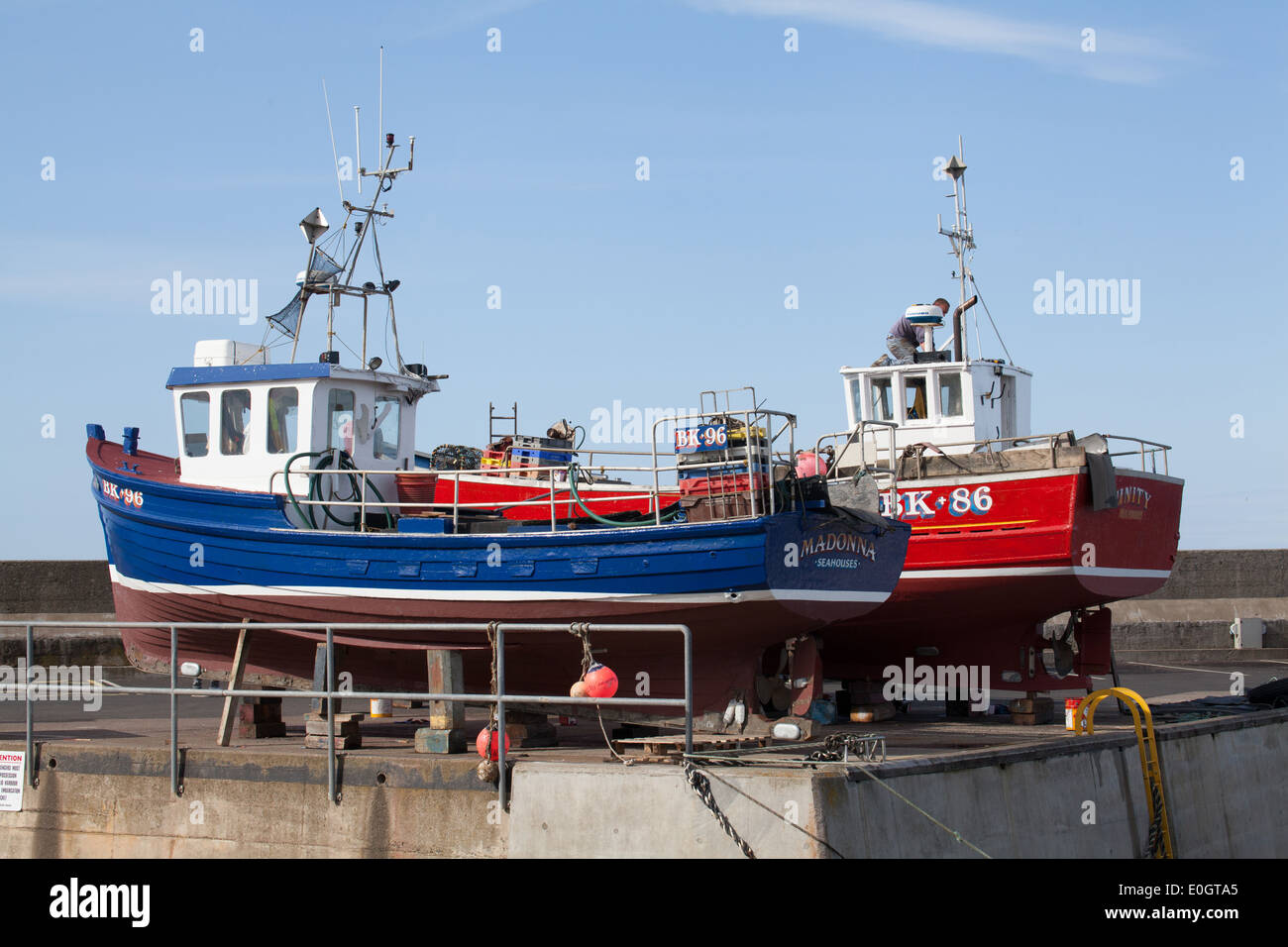 blue and red fishing boats at Seahouses harbour Northumberland UK Stock ...