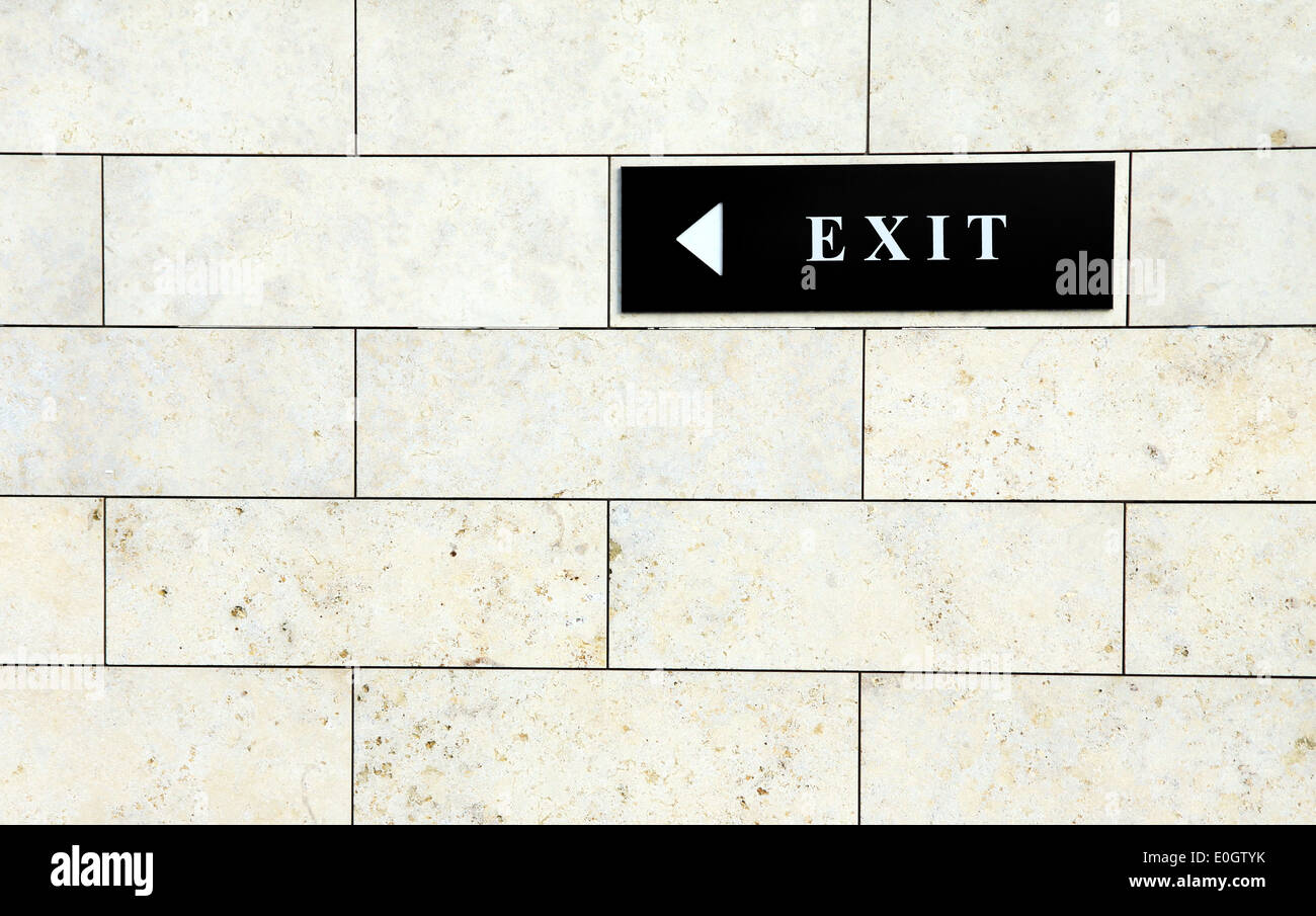 Black exit sign on the white wall Stock Photo Alamy