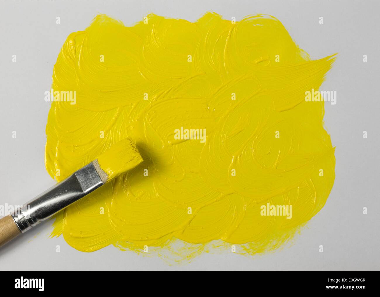 Yellow paint with paintbrush Stock Photo