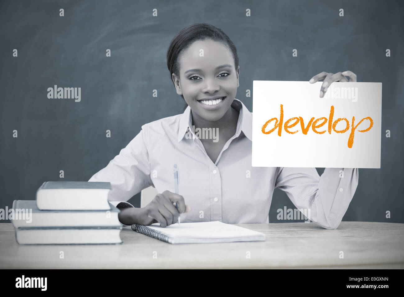 Happy teacher holding page showing develop Stock Photo