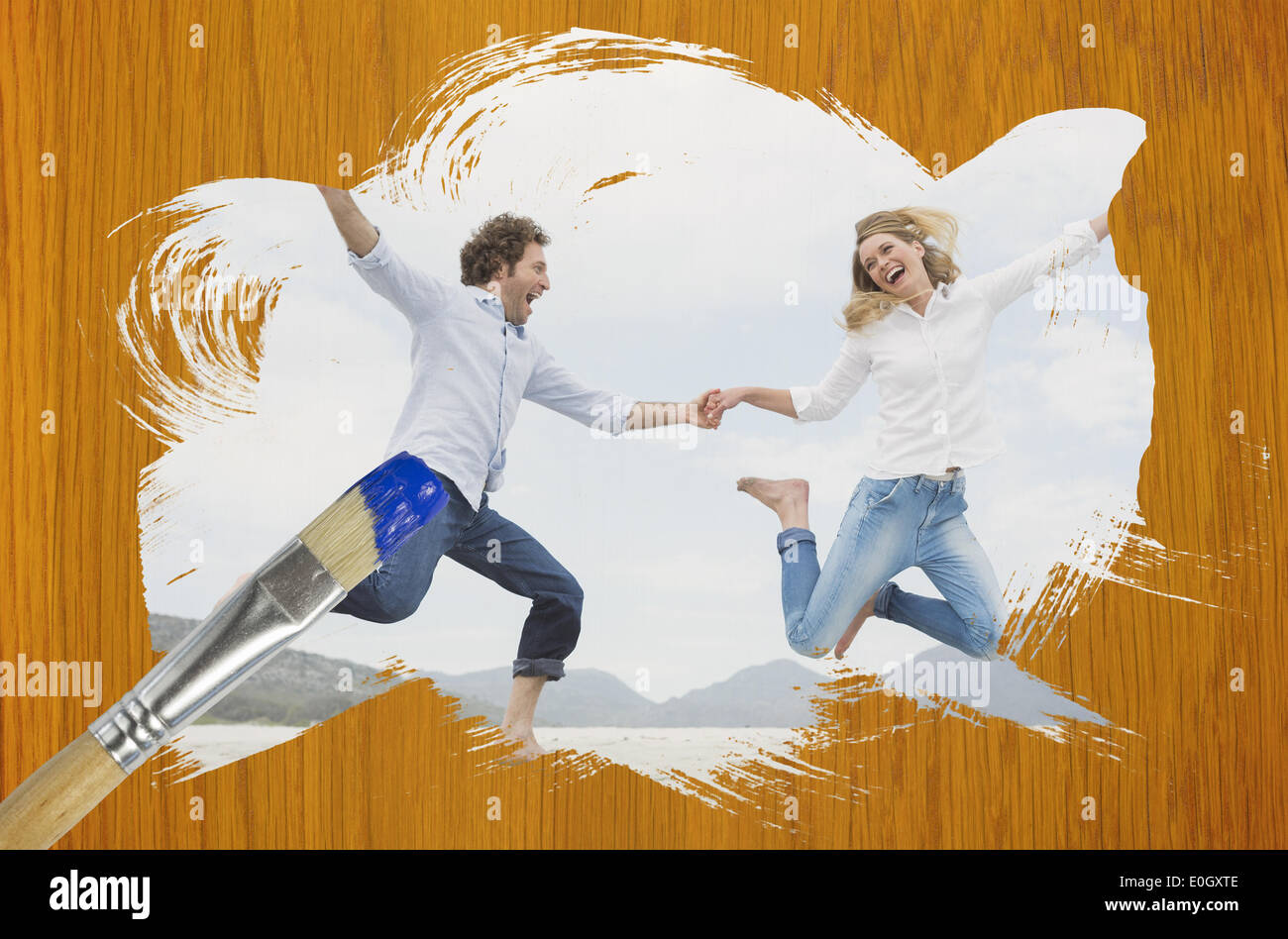 Composite image of couple jumping on the beach Stock Photo