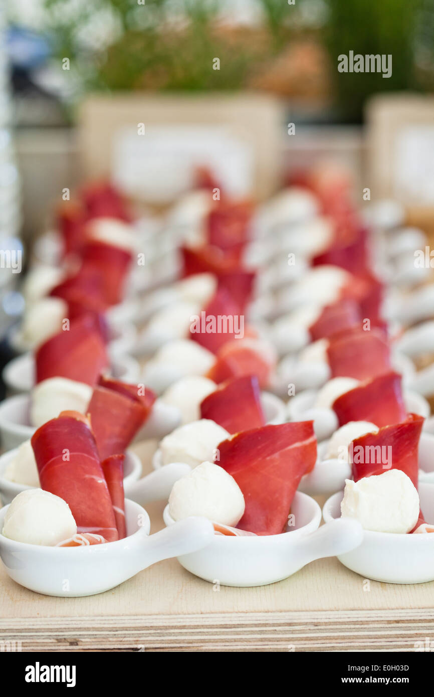 Closeup of prosciutto ham and ball shaped mozzarella cheese appetizers