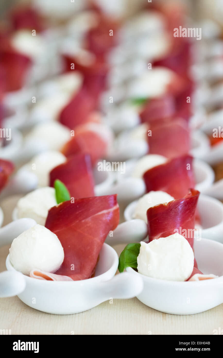 Closeup of prosciutto ham and ball shaped mozzarella cheese appetizers