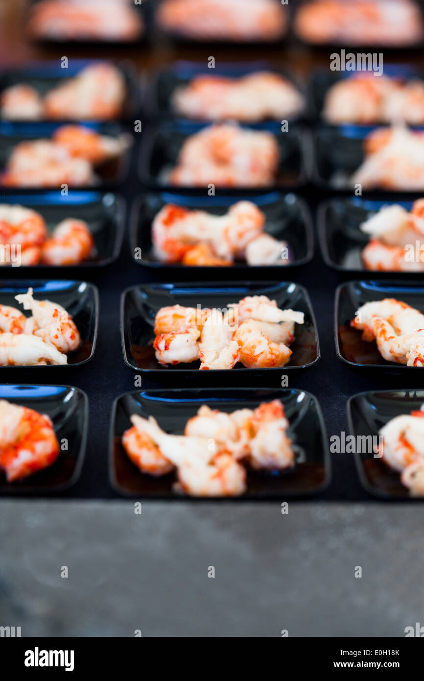Closeup of shrimp appetizers on small serving trays in rows Stock Photo
