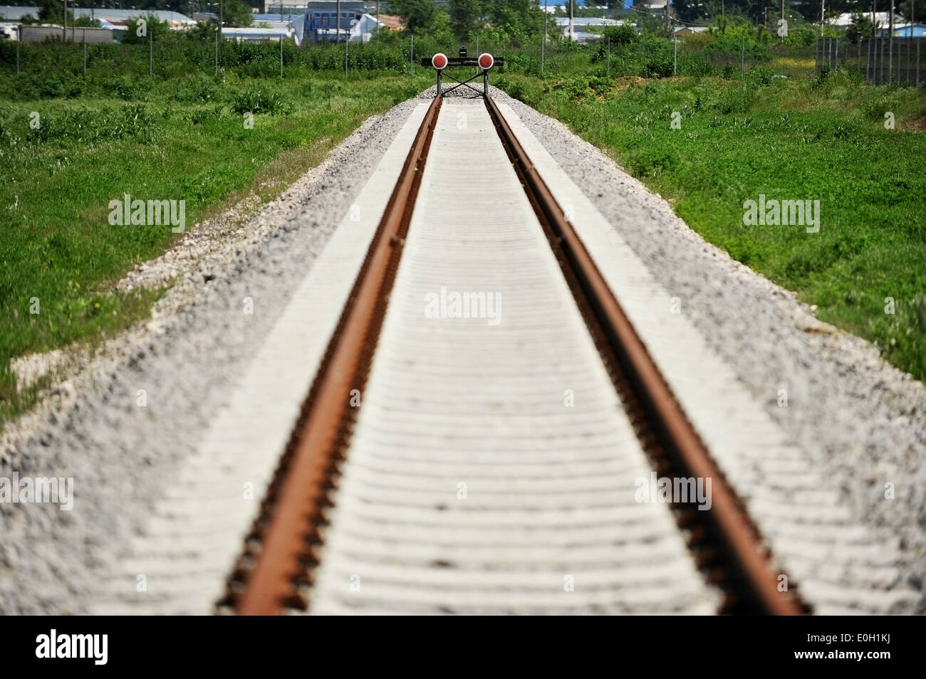Empty industrial railway with buffer stop Stock Photo