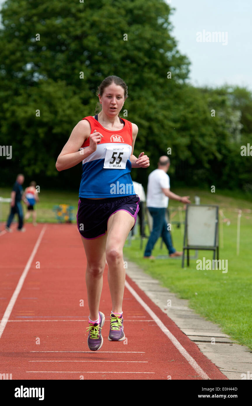 Athletics, competitor finishing women`s 3000m race at club level, UK ...