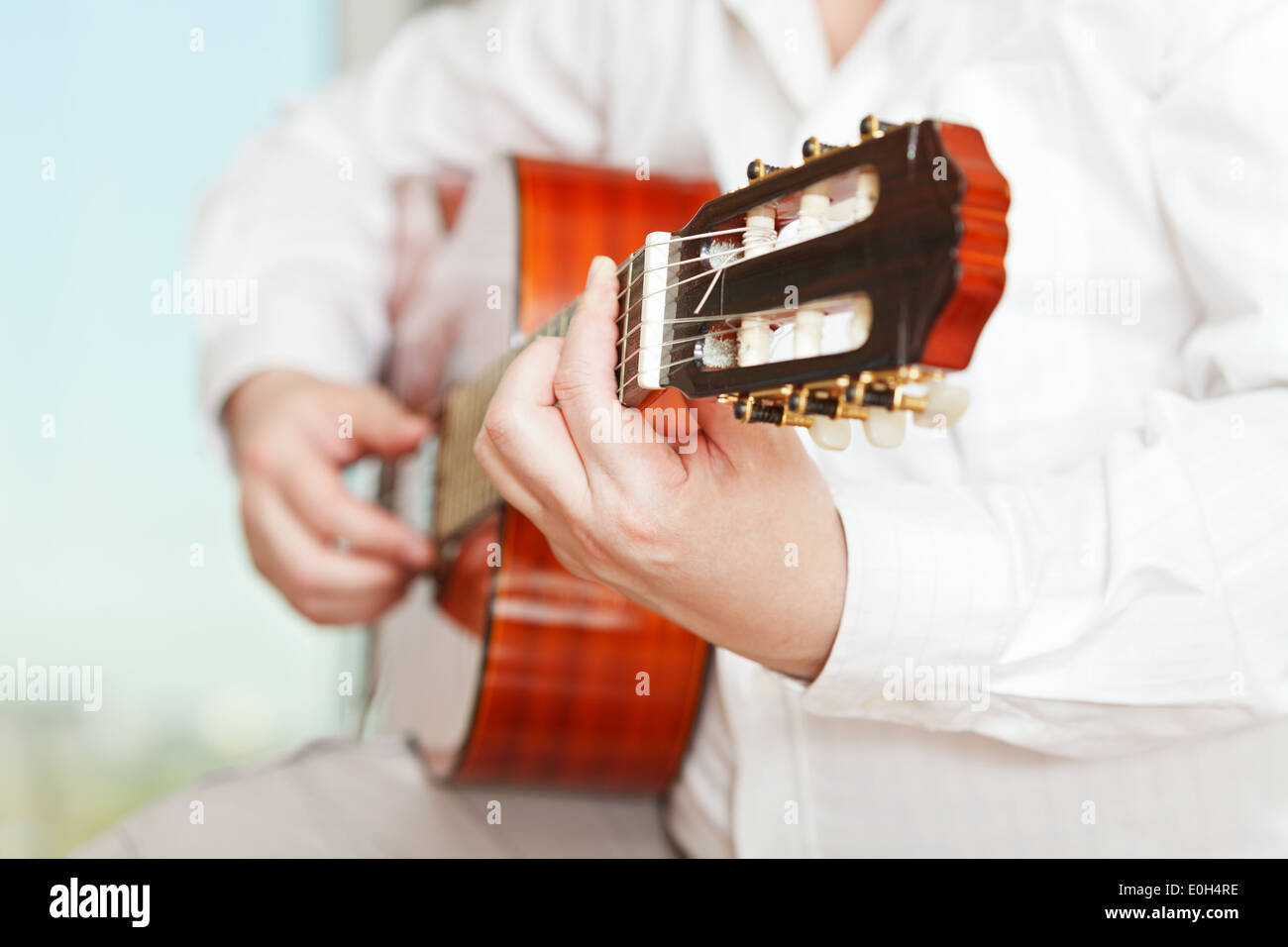 man plays on classical acoustic guitar close up Stock Photo