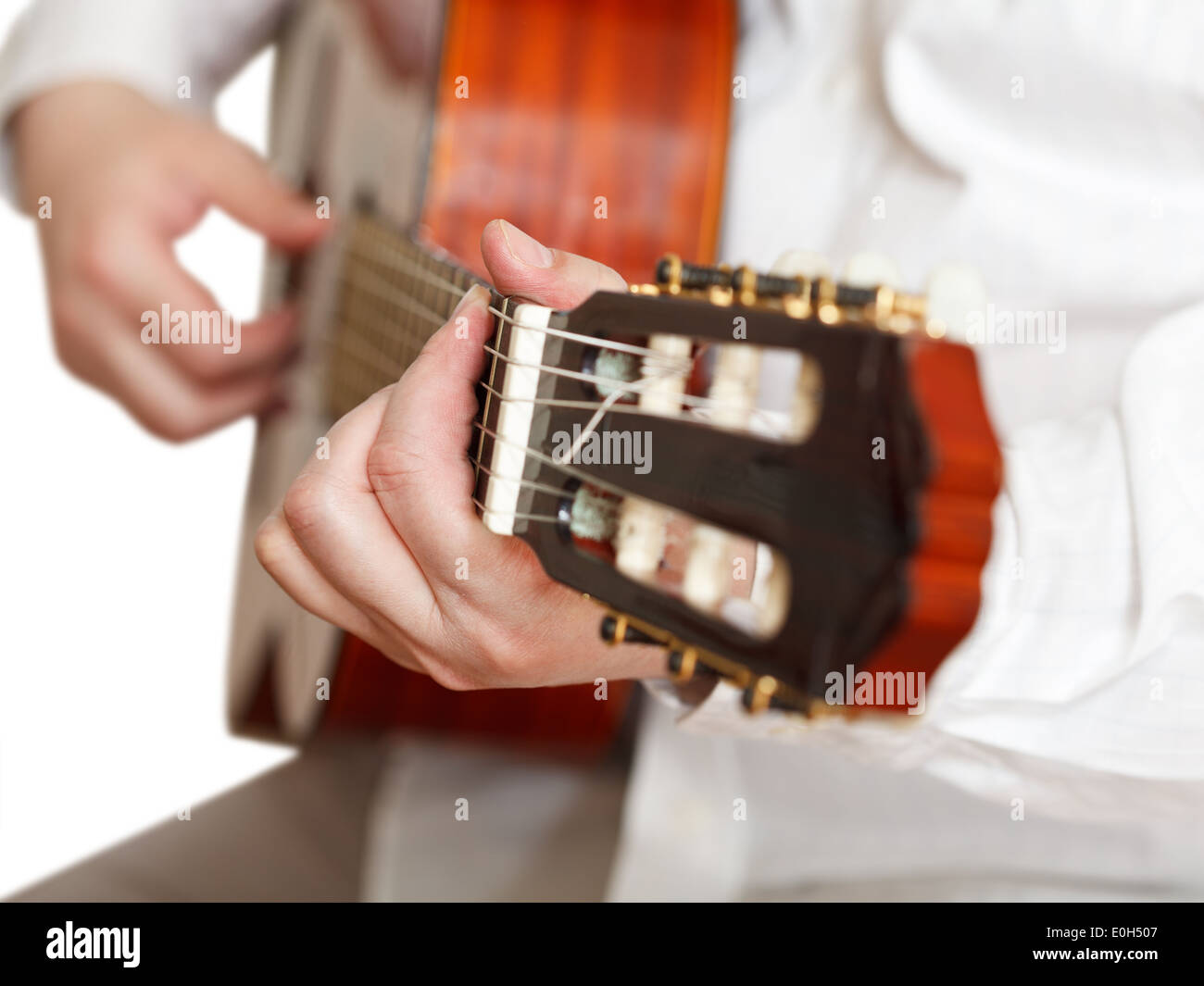 man plays on classical acoustic guitar close up isolated on white background Stock Photo
