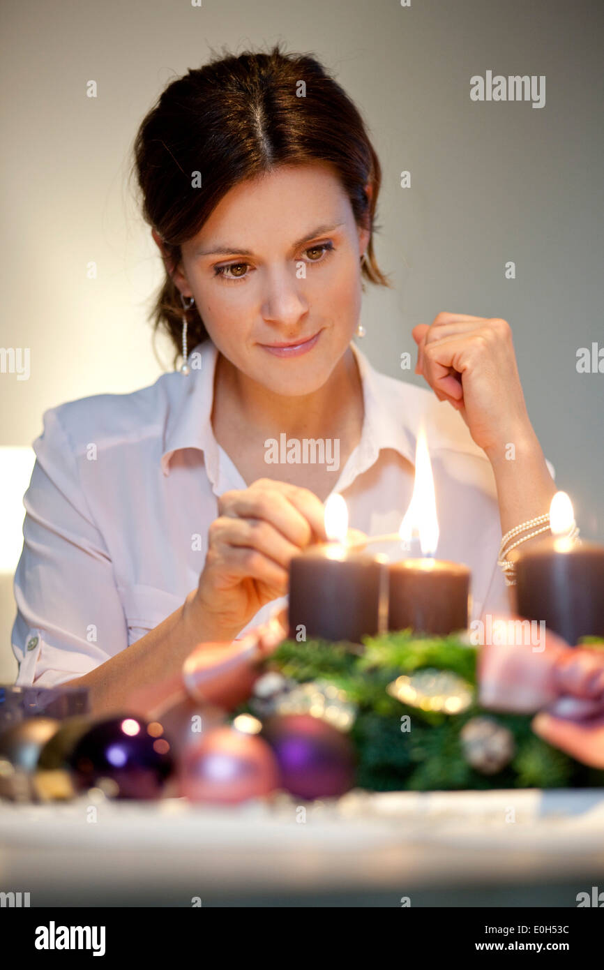 Mid adult woman lighting candle hires stock photography and images Alamy
