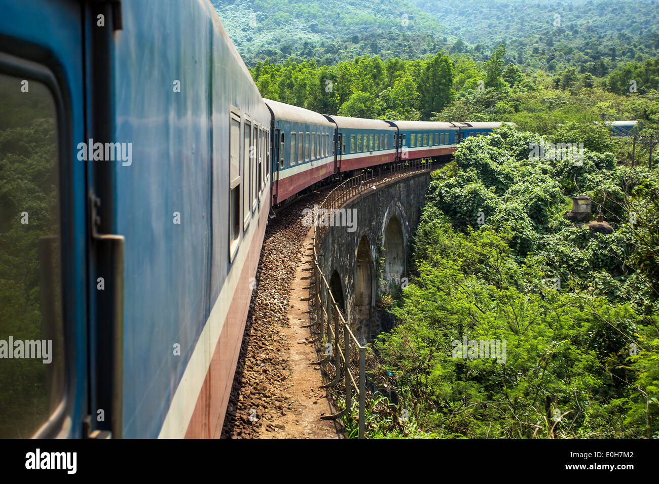 Old train passing over the viaduct. View from the window Stock Photo