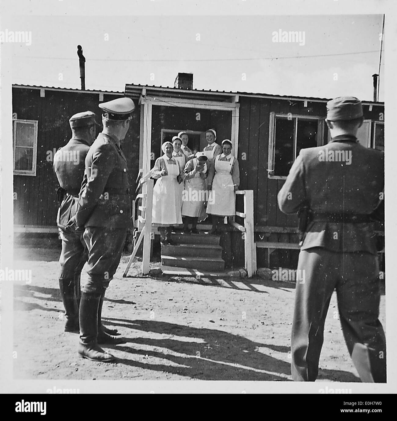 A photograph depicting a visit to a soldier's home during the Second ...