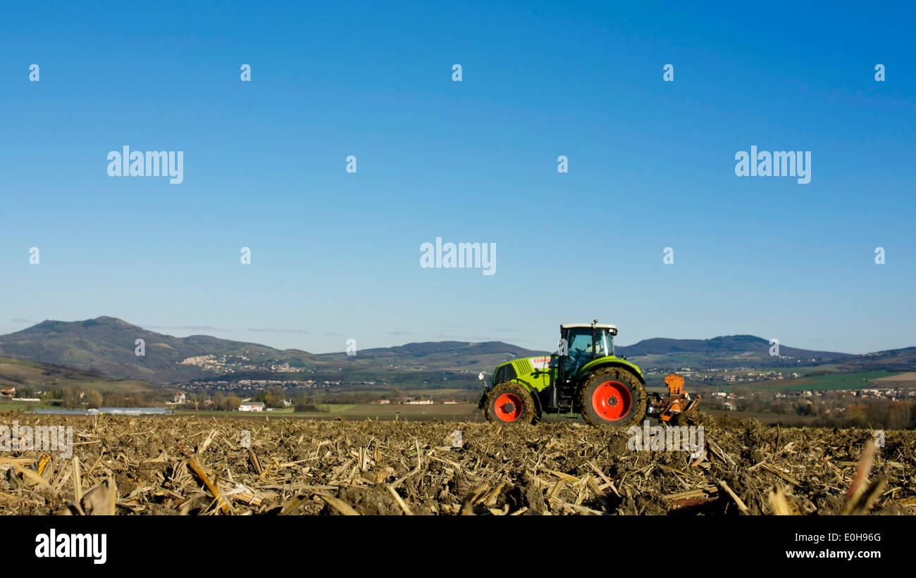 Agriculture and farming, a tractor in a field in France, Europe Stock Photo