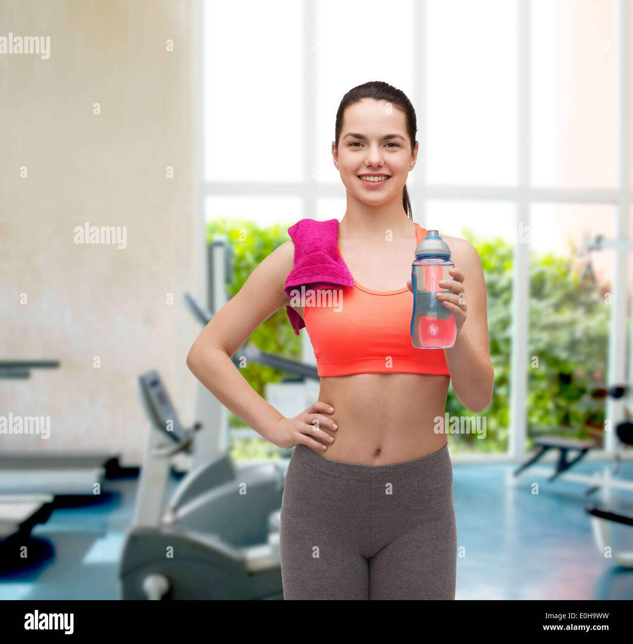 sporty woman with towel and water bottle Stock Photo - Alamy