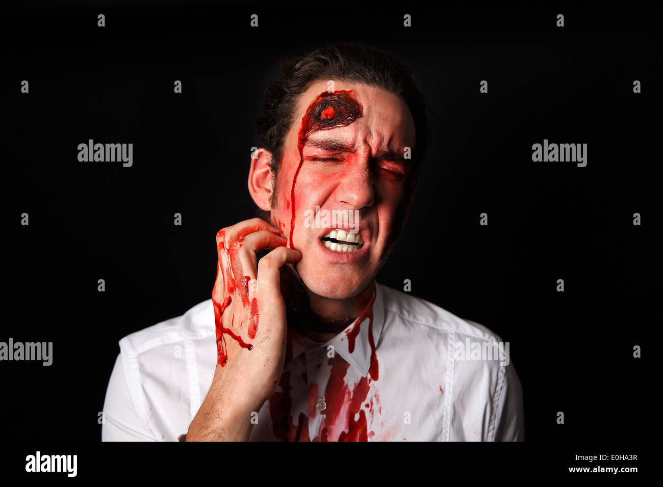 Psychopath with bloody scarsin a white shirt Stock Photo