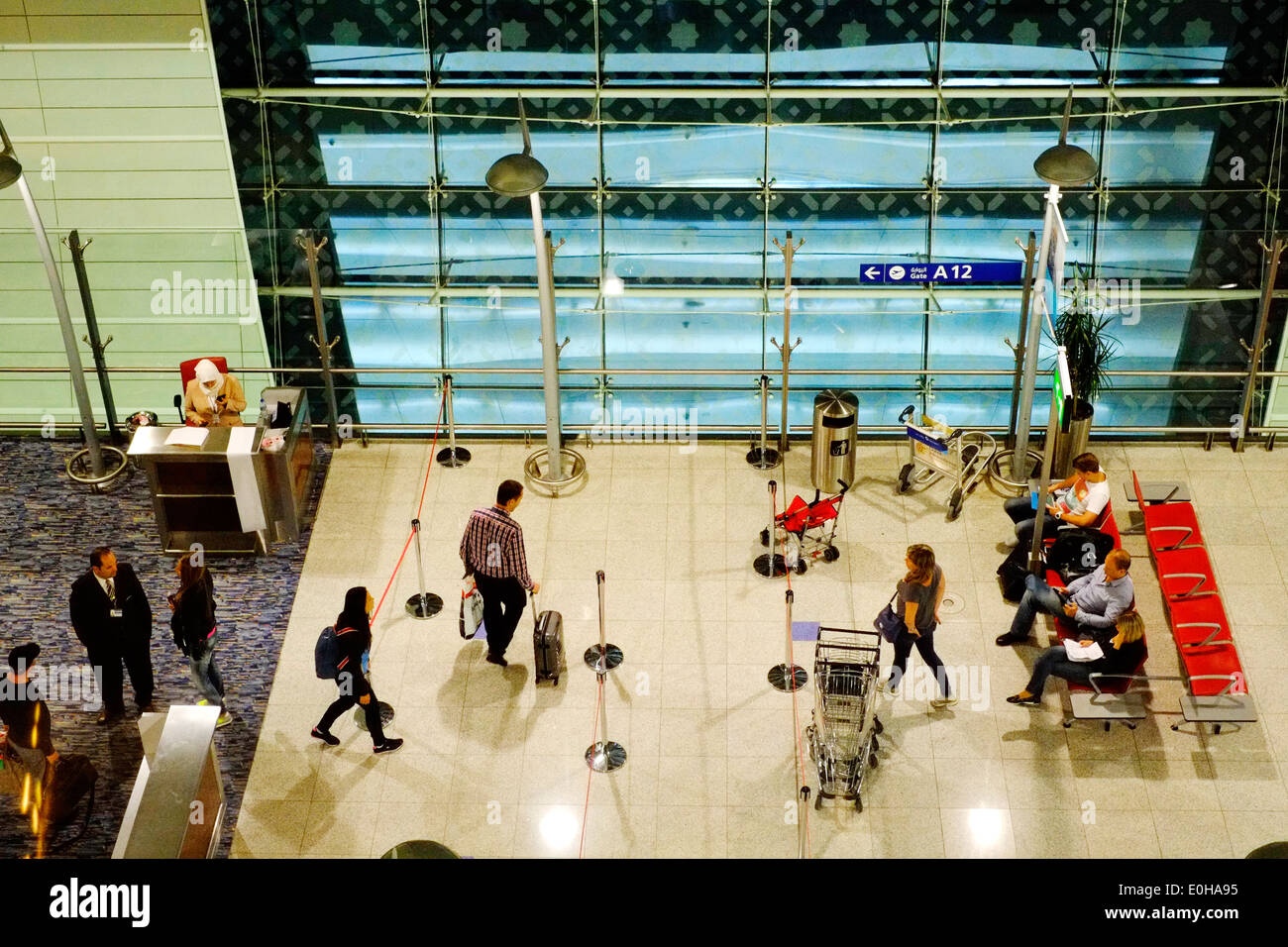 passengers in the departure lounge in the early hours of the morning at dubai international airport Stock Photo